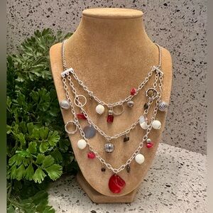 Red, white and silver tone charm necklace